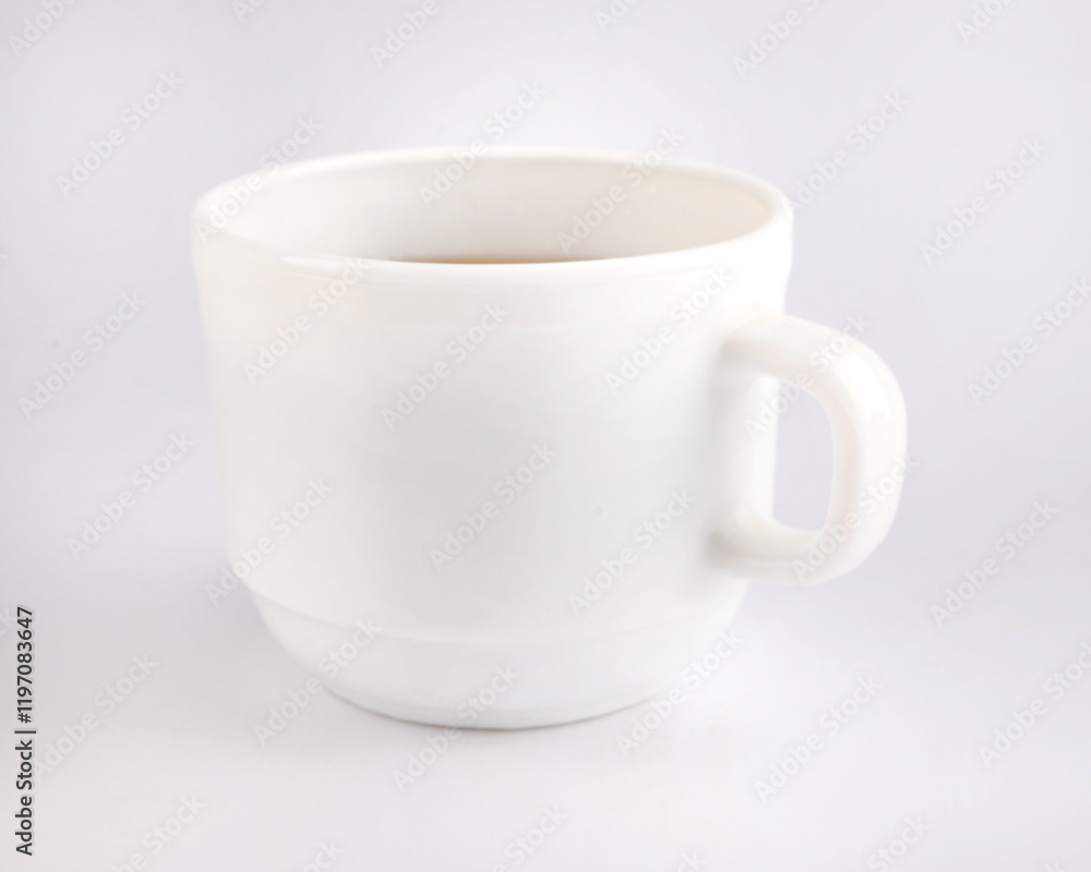 White cup with tea on a white background. White cup with tea on a white background.