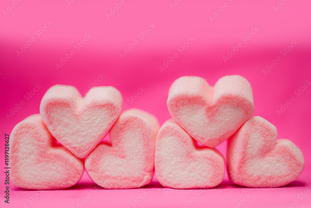 Fototapeta premium sweet heart shape of marshmallows on pink background.