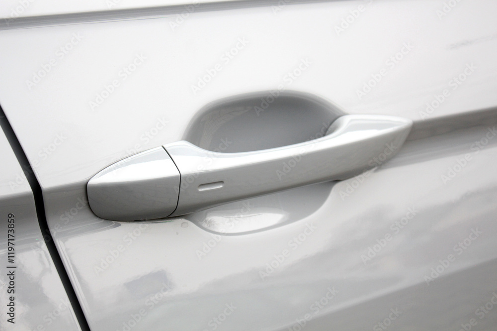 Gray car door handle with keyless entry. The outside of a car door handle. Modern car exterior door handle close up. Keyless locking and unlocking. Gray car door handle with keyless entry. The outside of a car door handle. Modern car exterior door handle close up. Keyless locking and unlocking.