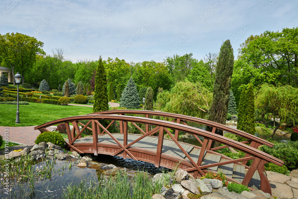 Wooden bridge in a park. Summer park with bridge. Wooden bridge in a park. Summer park with bridge.