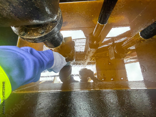 Heavy fuel oil tank overflow pipe deep tray with fuel residues inside on board of merchant cargo ship