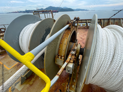 Mooring winch with new mooring lines on container vessel in poor corroded condition photo