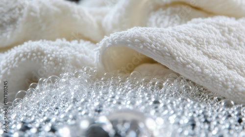 White towels soaking in soapy water for laundry day photo