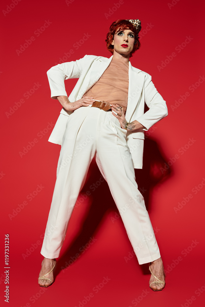A confident young man showcases his unique style in elegant attire while posing dramatically. A confident young man showcases his unique style in elegant attire while posing dramatically.