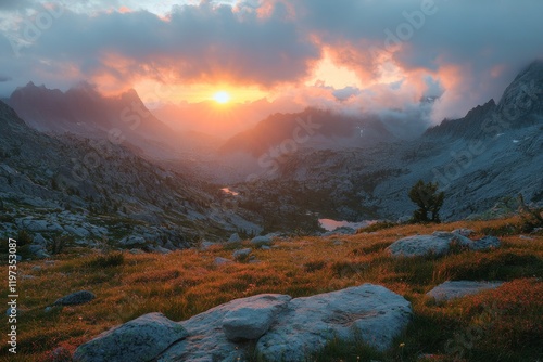 Sunset over rugged mountain landscape with vibrant sky and rocky terrain