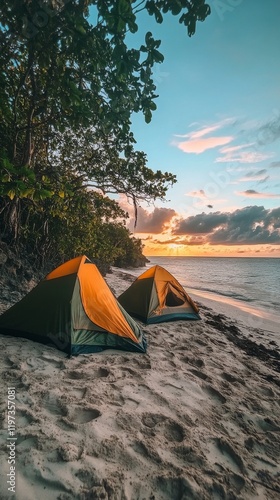 Camping by the ocean under a clear sky with two tents on the sandy beach