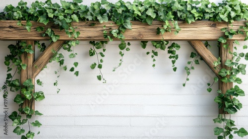 Wooden trellis adorned with green ivy against a white wall in a tranquil indo...