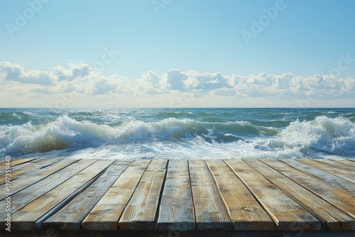 Waves crashing against a wooden dock under a bright blue sky on a sunny day