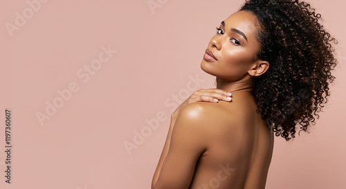Beautiful Woman with Curly Hair Smooth Skin Pink Background Studio Portrait