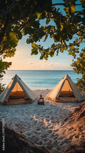 Camping by the ocean under a clear sky with two tents on the sandy beach