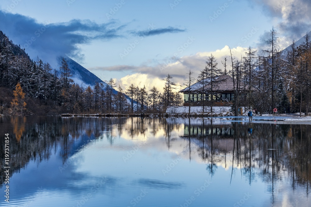 Fototapeta premium Sichuan Aba Prefecture Bipenggou sunset showcases reflections over a tranquil lake and mountains