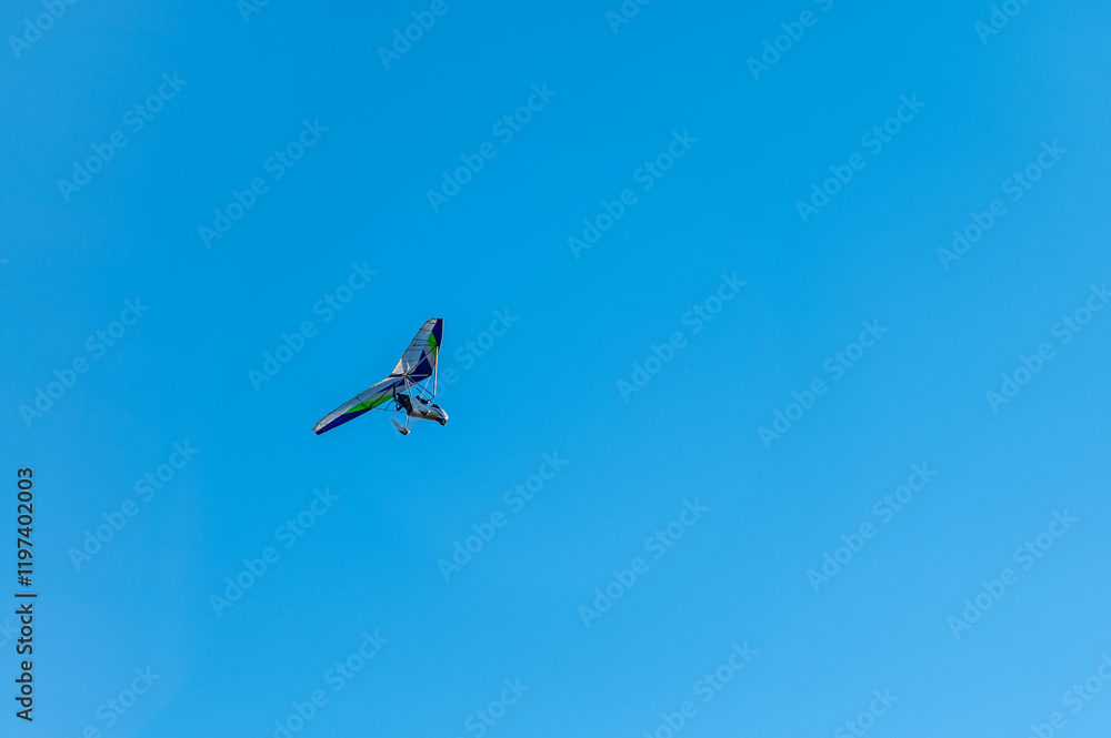 White Hang Glider against blue sky White Hang Glider against blue sky