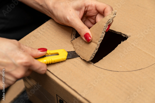 Fotografie DIY cardboard cutting utility knife, drawing precise circular shapes for crafting, recycling, packaging, gift box making, creative tutorials, pet house and tunnel designs