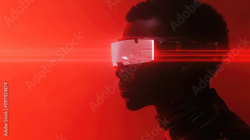 African American man wearing futuristic VR headset in striking red lighting against minimalist backdrop with ample copyspace for text placement photo