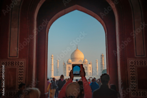 Photography Tourists take photos of the Taj Mahal at sunrise.  India