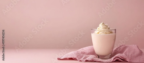 Creamy dessert in glass cup on pink checkered towel against soft pink background with empty space for text, perfect for food concepts and recipes. photo