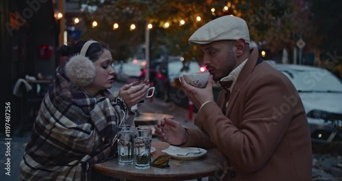 Wallpaper Mural A loving couple enjoys a warm drink together at an outdoor cafe on a chilly autumn evening in the city. Torontodigital.ca