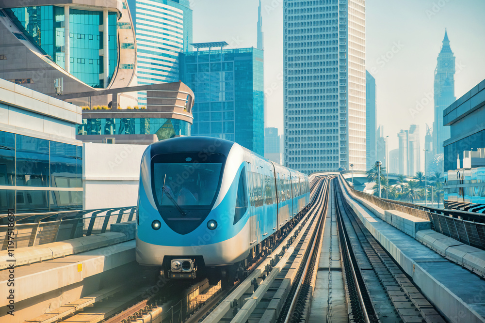 Naklejka premium Dubai metro train fully automated and driverless train system, seamlessly integrated into futuristic skyline, passing through modern skyscrapers and modern architecture in Dubai city