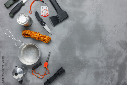 Bushcraft or survival equipment on concrete background. Flat lay composition.