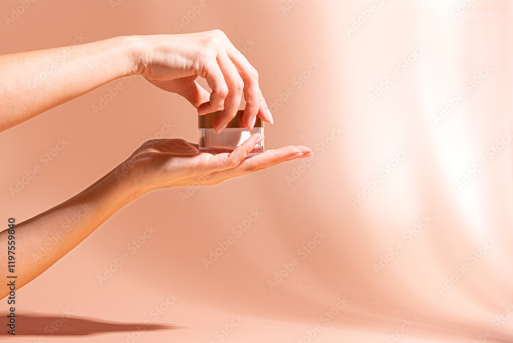 Naklejka premium Female hands open cream jar
