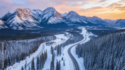 Aerial View of Snowy Mountain Roads Winding Through Majestic Winter Landscapes