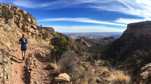 Trail Runner in Stunning Rocky Desert and Canyon Landscapes Under a Vibrant Blue Sky
