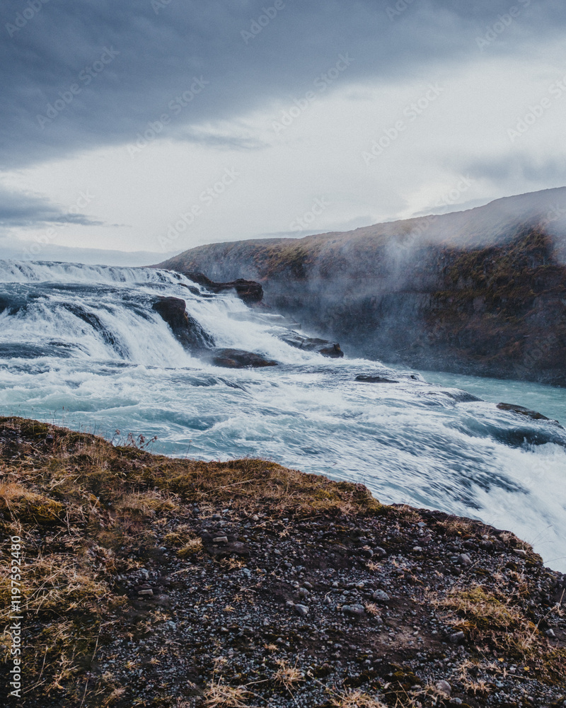 Fototapeta premium Side view of the cascading Gullfoss waterfall in south Iceland's rugged landscape...