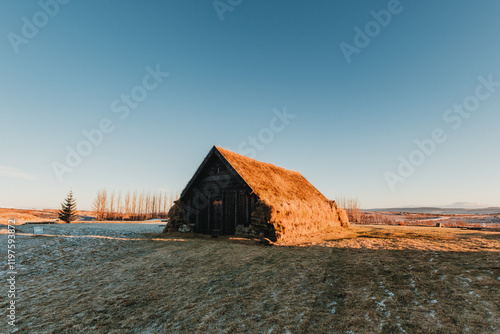 Traditional Icelandic turf house in Thorlaksbud, south Iceland, at sunrise... photo