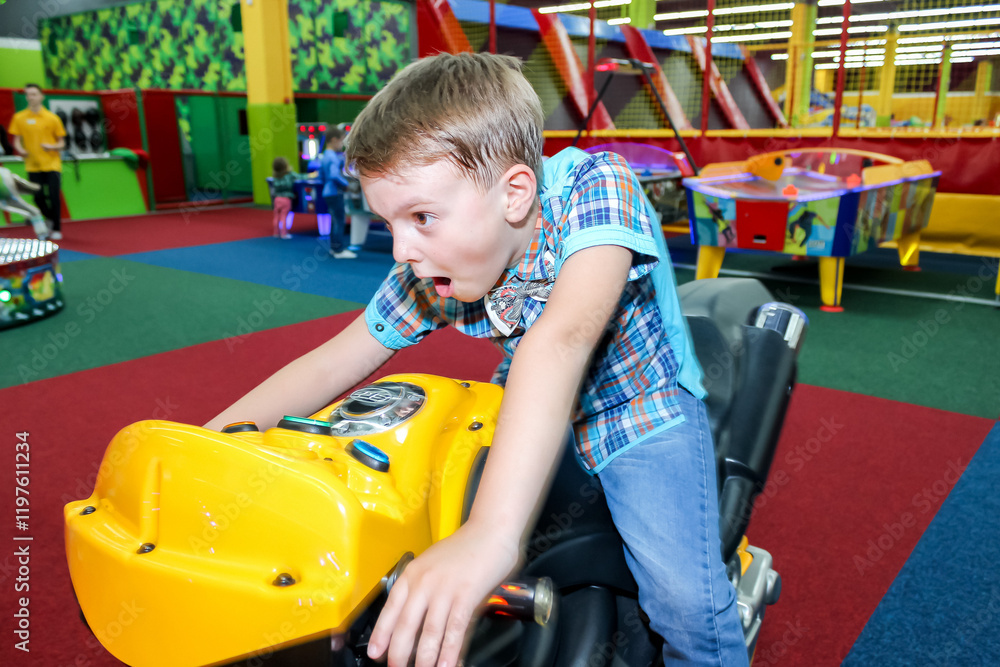 boy, 7 years old, rides a motorcycle, attraction, grimaces, checkered shirt, entertainment center, sport, birthday, teenager, holiday, child, boy, 7 years old, rides a motorcycle, attraction, grimaces, checkered shirt, entertainment center, sport, birthday, teenager, holiday, child,