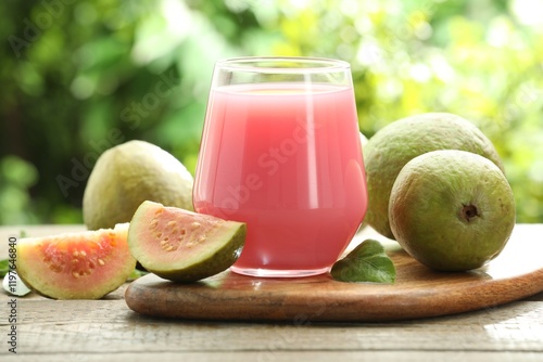 Refreshing guava juice and fresh fruits on wooden table, closeup photo