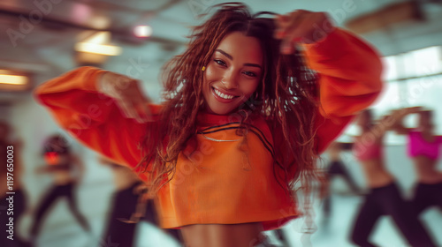 Obraz na płótnie Curly-haired girl grooving to hip hop in a lively dance class, with blurred dancers in the background. Energetic, rhythmic, and focused, capturing the dynamic vibe of urban dance culture w salonie