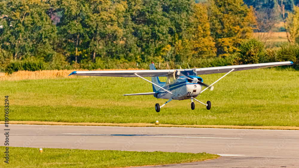 Sports aircraft landing on a sunny summer day at Straubing airport, Bavaria, Germany Sports aircraft landing on a sunny summer day at Straubing airport, Bavaria, Germany