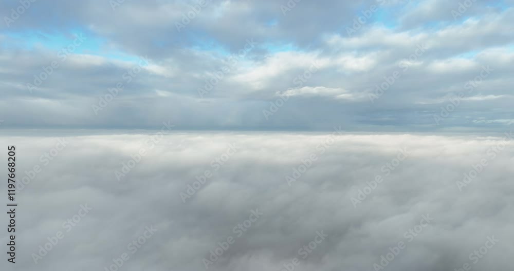 Flying through the clouds, horizon, and sky. Blue and white grey clouds. Flying through the clouds, horizon, and sky. Blue and white grey clouds.