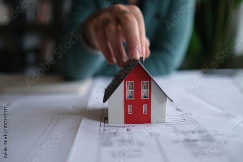 Architect man holding pencil working with laptop and blueprints for architectural plan, engineer sketching a construction project concept.