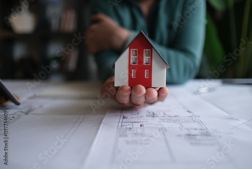 Architect man holding pencil working with laptop and blueprints for architectural plan, engineer sketching a construction project concept.