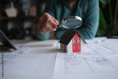 Architect man holding pencil working with laptop and blueprints for architectural plan, engineer sketching a construction project concept.