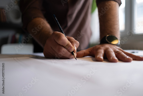 Architect man holding pencil working with laptop and blueprints for architectural plan, engineer sketching a construction project concept.