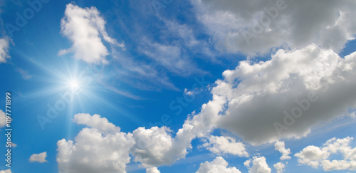 Tableau sur toile Blue sky with white clouds and bright sun.