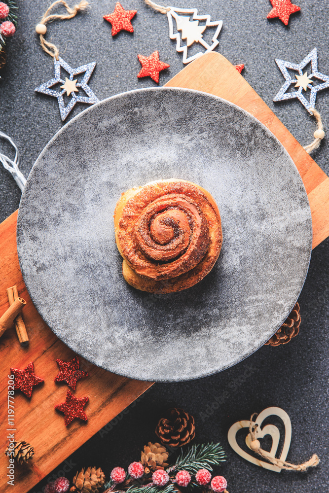 Cinnamon Rolls brioches or cinnamon rolls with icing sugar and cream cheese - decorated for Christmas