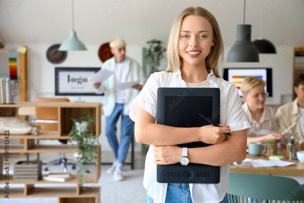 © Pixel-Shot - Female graphic designer with tablet working in office © Pixel-Shot - Female graphic designer with tablet working in office