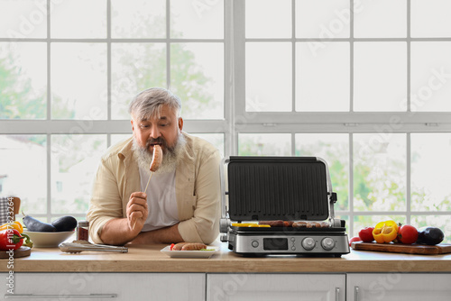 Mature man with cooked tast...