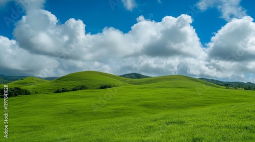 Lush green hills under cloudy sky in serene landscape photo