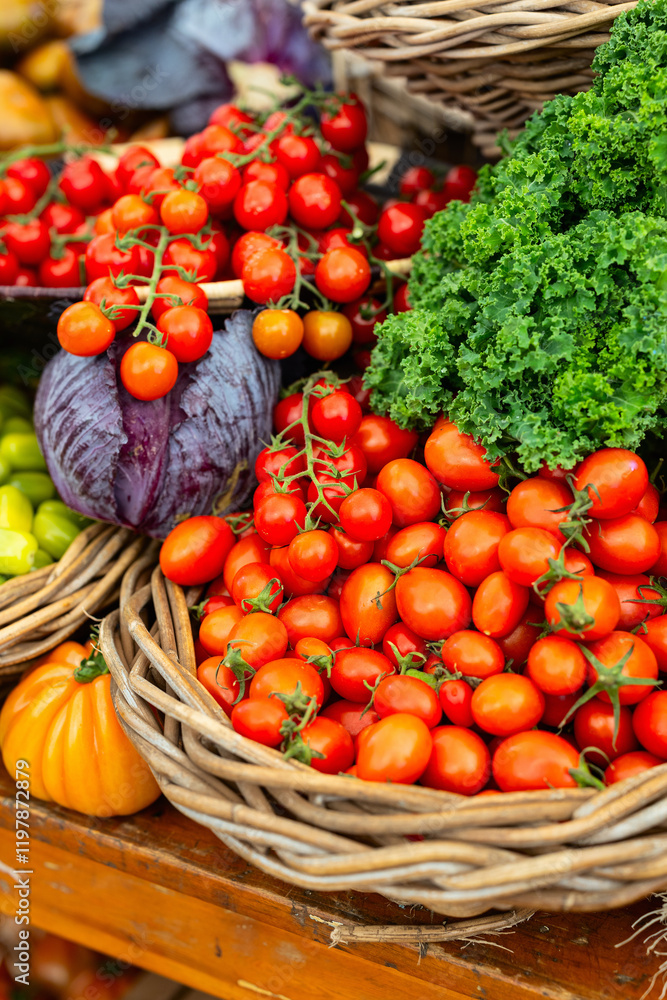 Cherry tomatoes with kale and purple cabbage in basket Cherry tomatoes with kale and purple cabbage in basket