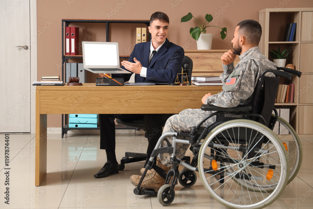 Male lawyer showing laptop to soldier in wheelchair at office Male lawyer showing laptop to soldier in wheelchair at office