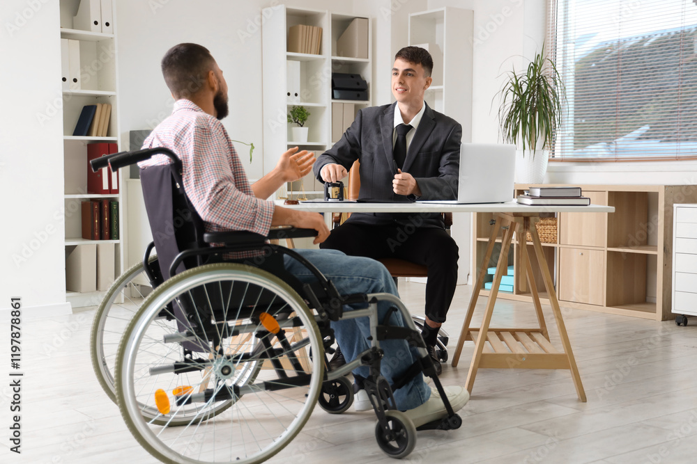 Young lawyer stamping document with man in wheelchair at office Young lawyer stamping document with man in wheelchair at office