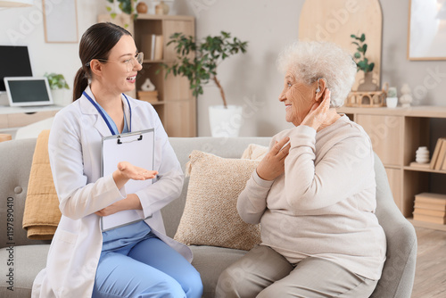 Senior woman with hearing a...