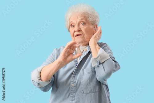 Shocked senior woman with h...