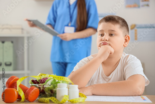 Thoughtful overweight boy a...