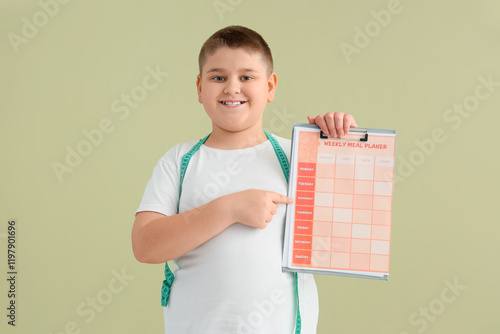 Overweight boy pointing at ...