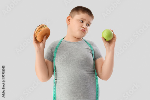 Thoughtful overweight boy w...